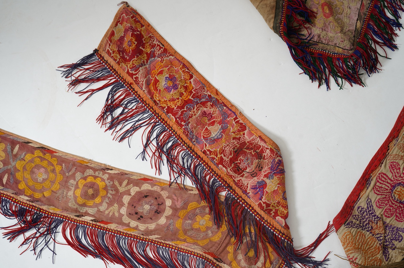 Five various sized late 19th / early 20th century Usbek Saye Gosha (V shaped) Suzani silk embroidered bridal yurt wall hangings, usually forming part of a dowry, two with later fringing, longest 172cm. Condition - some f